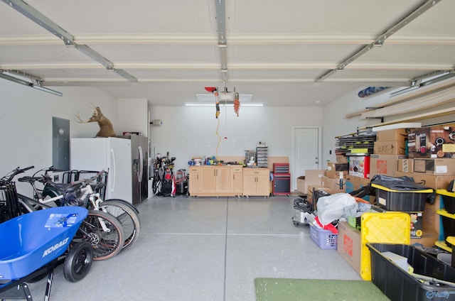 14267 Leadenhall Ln, Athens, AL 35613 - garage with white refrigerator with ice dispenser and electric panel