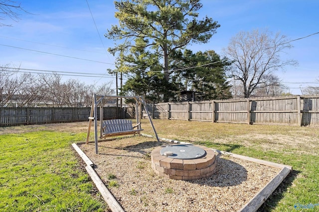 view of yard featuring a fire pit and a fenced backyard