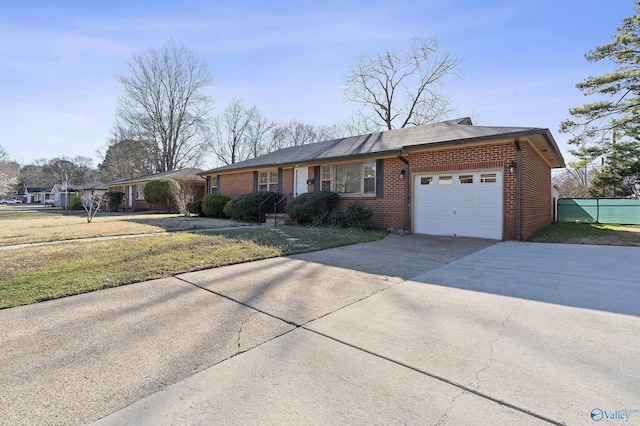 ranch-style home with brick siding, concrete driveway, a garage, and fence