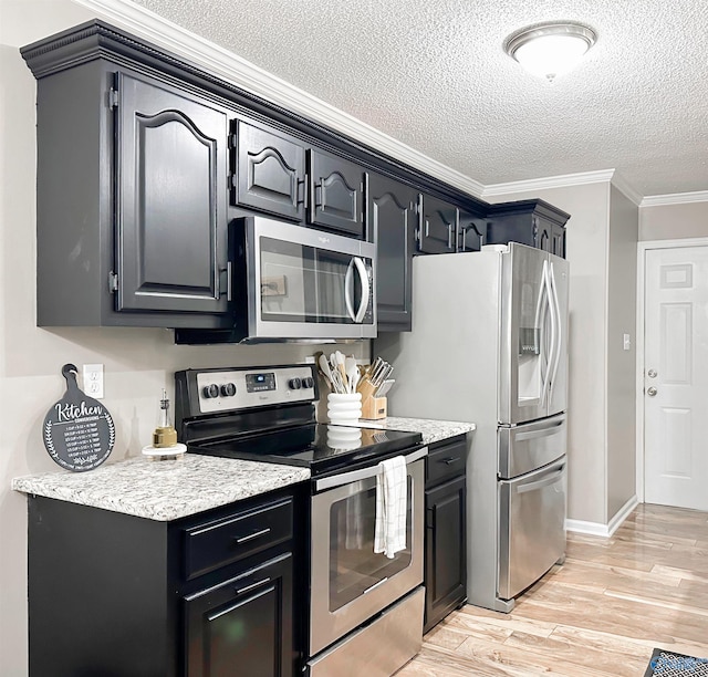 108 Mountain Home Rd, Trinity, AL 35673 - kitchen featuring appliances with stainless steel finishes, a textured ceiling, ornamental molding, light wood-type flooring, and baseboards