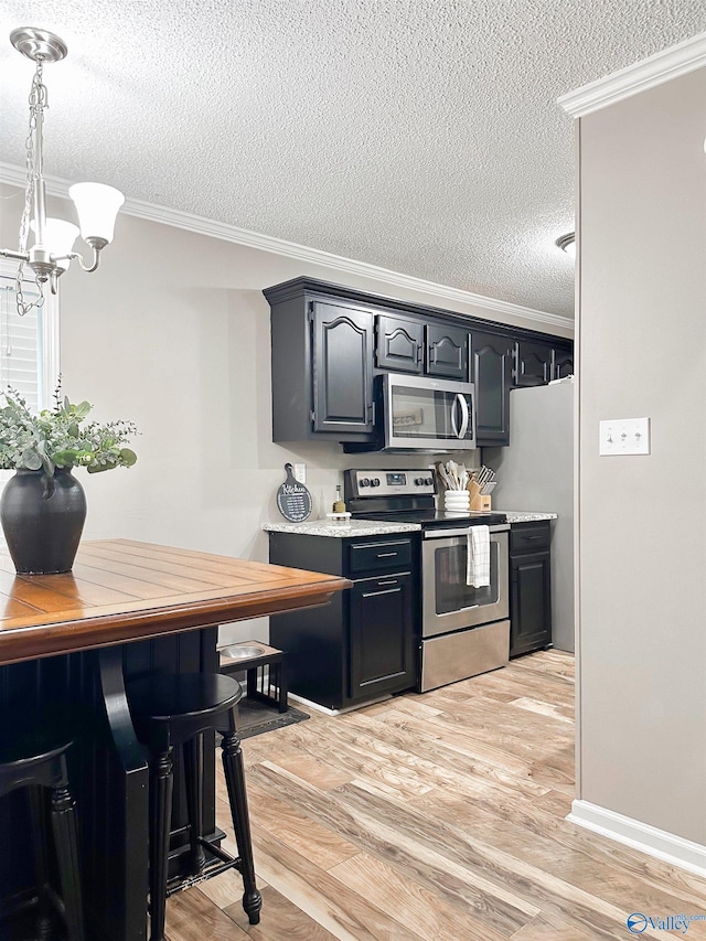 108 Mountain Home Rd, Trinity, AL 35673 - kitchen featuring stainless steel appliances, a textured ceiling, ornamental molding, a chandelier, and light countertops