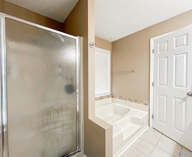 108 Mountain Home Rd, Trinity, AL 35673 - full bathroom with a textured ceiling, a garden tub, tile patterned flooring, and a stall shower