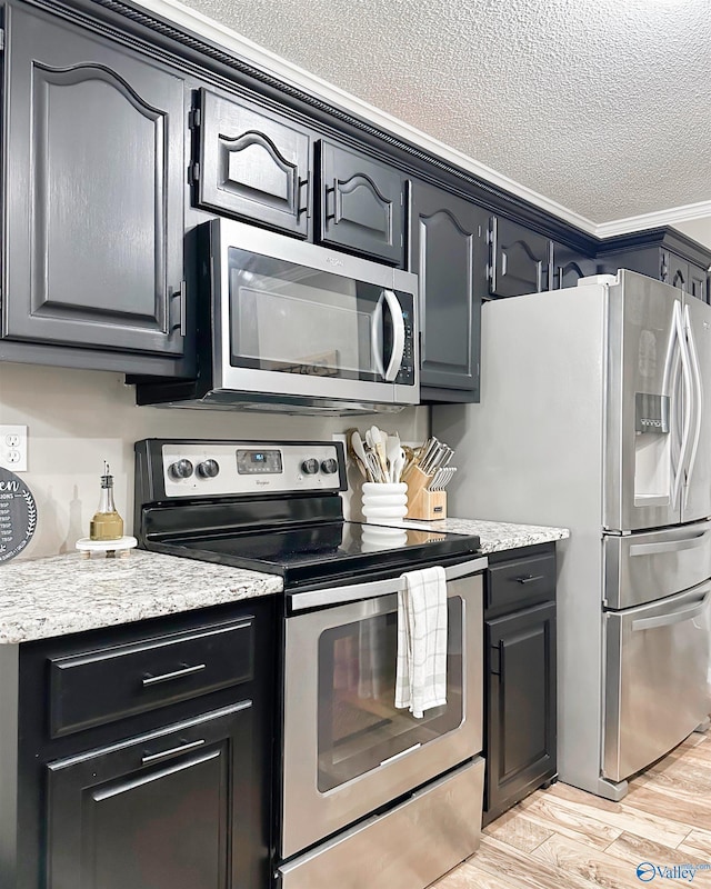 108 Mountain Home Rd, Trinity, AL 35673 - kitchen featuring stainless steel appliances, a textured ceiling, light wood-style flooring, ornamental molding, and light stone countertops