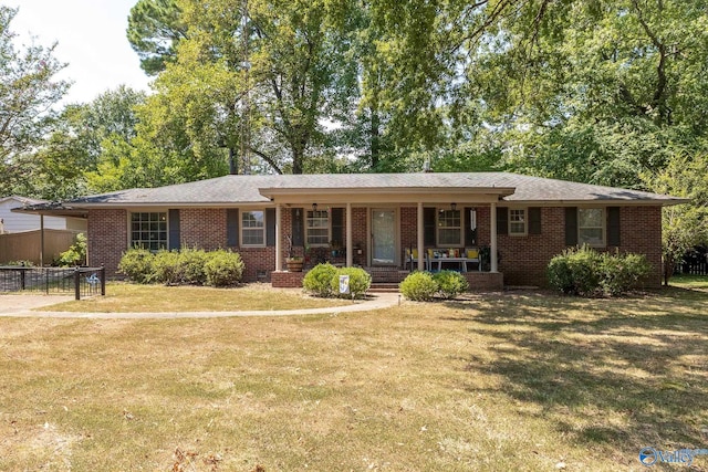 ranch-style home featuring a front yard and a porch