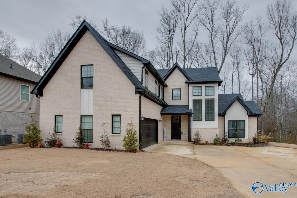 view of front of house featuring a garage and central air condition unit