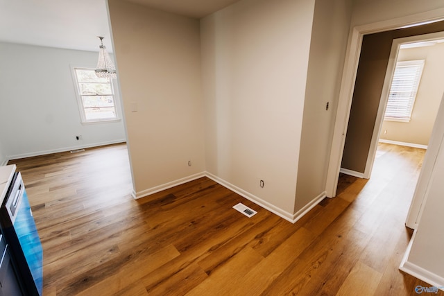 unfurnished room with hardwood / wood-style flooring