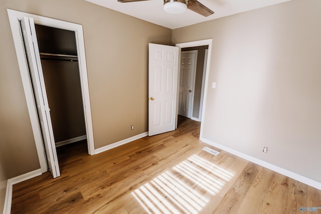 unfurnished bedroom featuring wood-type flooring, a closet, and ceiling fan