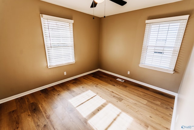 spare room featuring hardwood / wood-style floors and ceiling fan