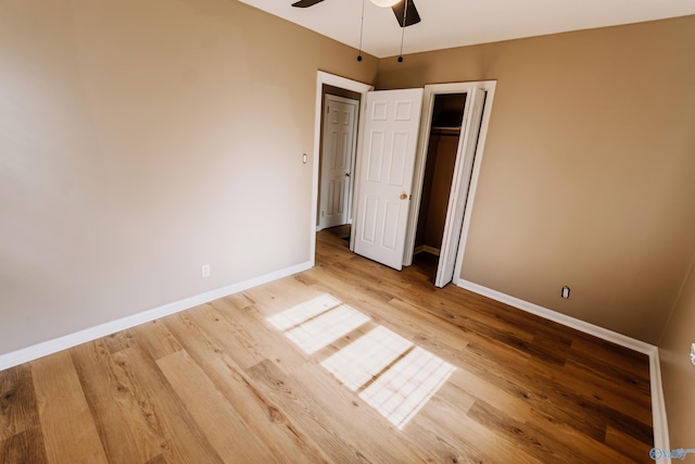 unfurnished bedroom featuring hardwood / wood-style flooring, a closet, and ceiling fan