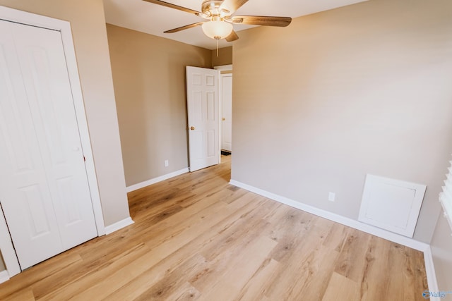 unfurnished bedroom featuring a closet, ceiling fan, and light hardwood / wood-style flooring