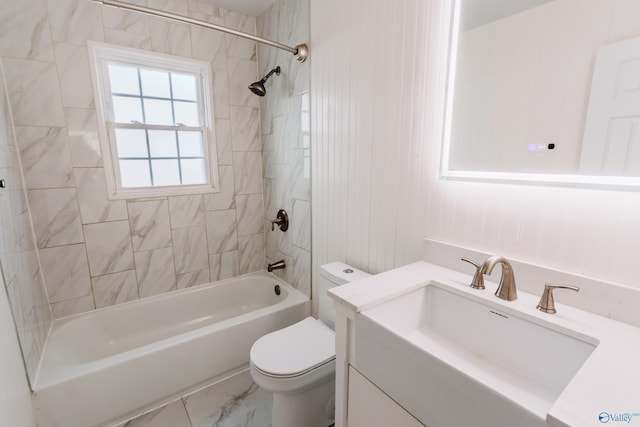 full bathroom featuring tiled shower / bath combo, vanity, and toilet