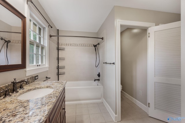 full bathroom featuring vanity, tiled shower / bath combo, toilet, and tile patterned floors