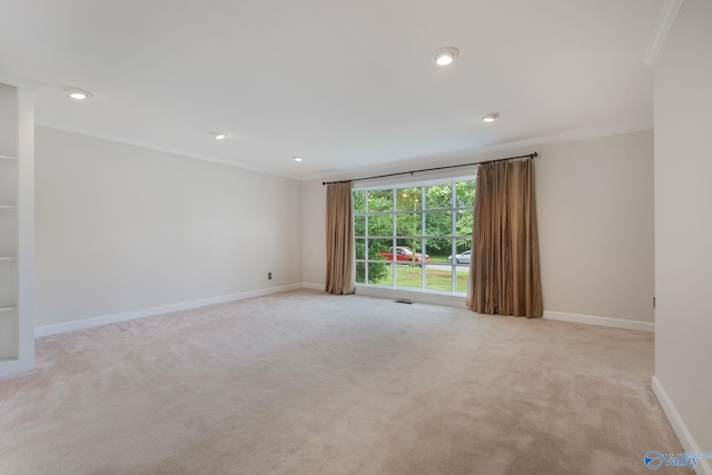 carpeted spare room with ornamental molding