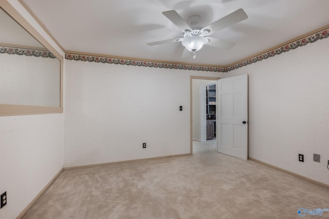 carpeted empty room featuring ceiling fan