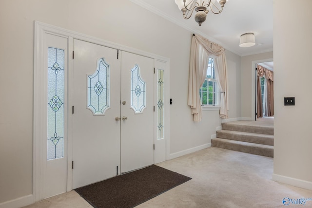 foyer entrance featuring an inviting chandelier, crown molding, and light carpet