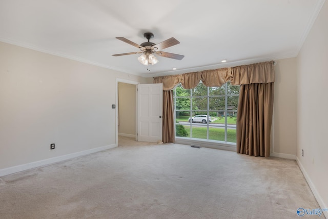 unfurnished room featuring light carpet, crown molding, and ceiling fan