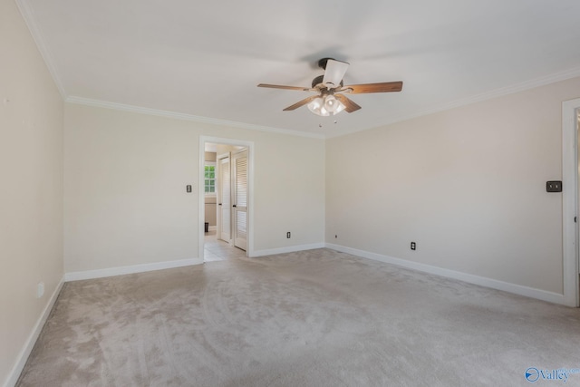 unfurnished room featuring crown molding, ceiling fan, and light colored carpet