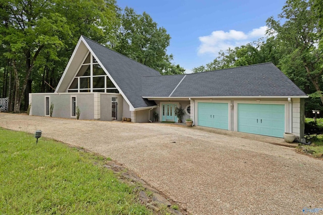 102 Fern Cv, Florence, AL 35634 - a-frame home with driveway, roof with shingles, and a garage