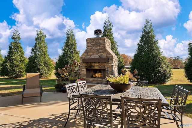 view of patio featuring an outdoor stone fireplace