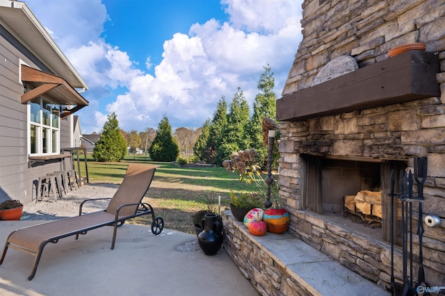 view of patio featuring an outdoor stone fireplace