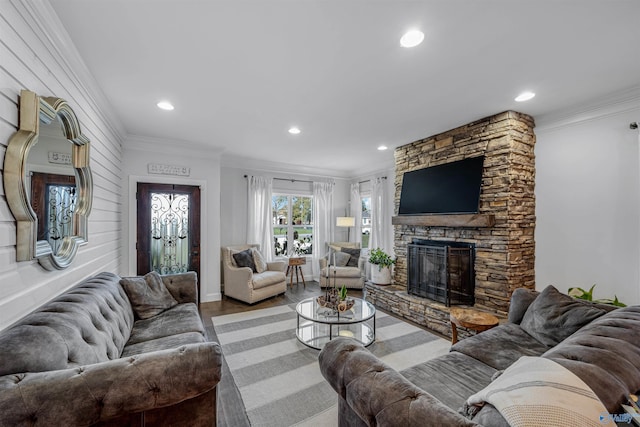 living room with crown molding, hardwood / wood-style floors, and a fireplace