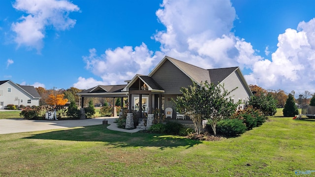 view of front facade with a carport and a front yard