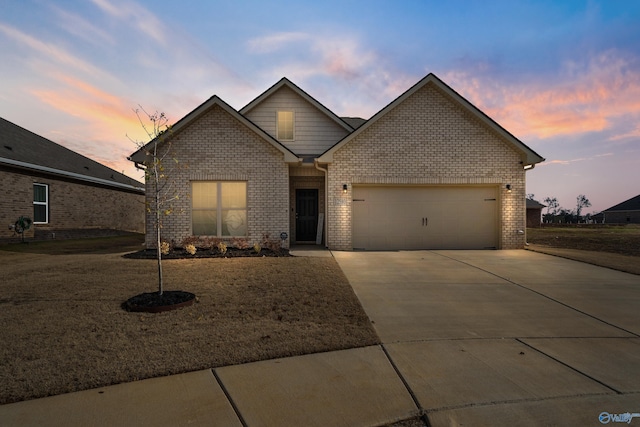 view of front facade with a garage and a lawn