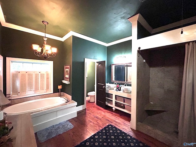 bathroom featuring hardwood / wood-style floors, a bathtub, crown molding, toilet, and a chandelier