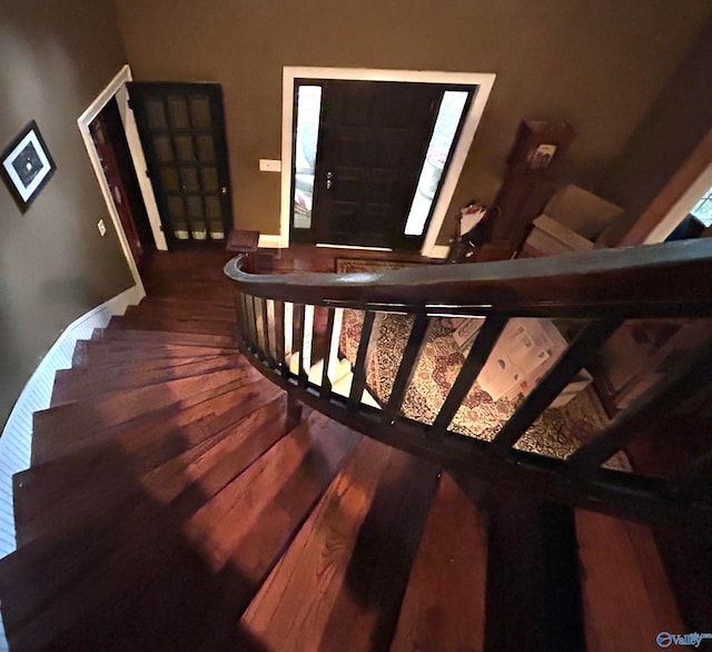 stairs featuring wood-type flooring