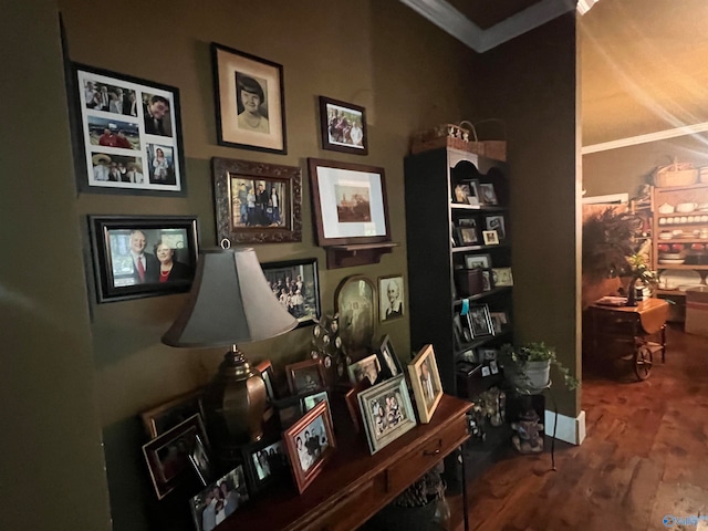 interior space featuring wood-type flooring and crown molding