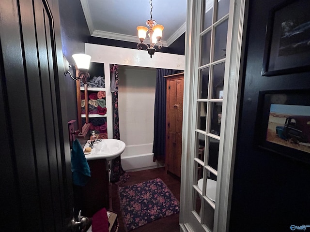 bathroom with a chandelier, shower / bath combination with curtain, ornamental molding, and sink