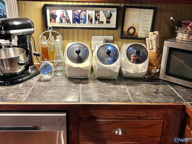 laundry room with wood walls