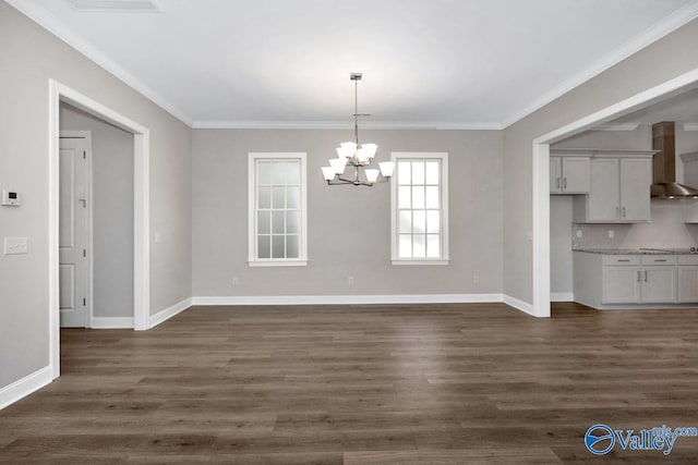 unfurnished dining area with an inviting chandelier, dark wood-type flooring, and ornamental molding