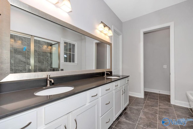 bathroom featuring vanity, an enclosed shower, and tile patterned flooring