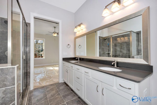 bathroom with vanity, ceiling fan, and walk in shower