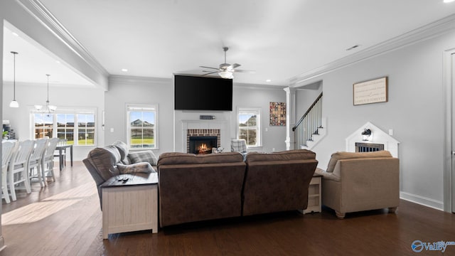 110 Ginamey Cir, Meridianville, AL 35759 - living room with a brick fireplace, ceiling fan, ornamental molding, dark wood-type flooring, and stairway