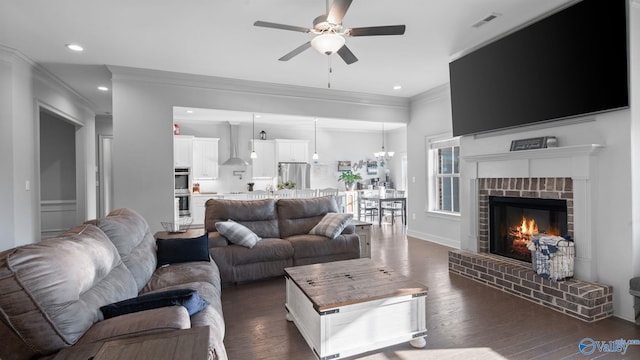 110 Ginamey Cir, Meridianville, AL 35759 - living area featuring ceiling fan, ornamental molding, dark wood-style flooring, a fireplace, and recessed lighting