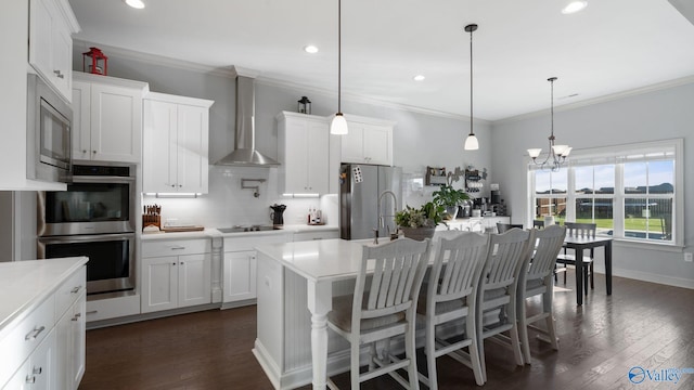 110 Ginamey Cir, Meridianville, AL 35759 - kitchen featuring stainless steel appliances, wall chimney range hood, decorative backsplash, light countertops, and recessed lighting