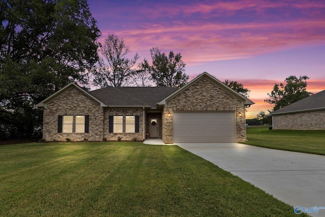 view of front facade featuring a garage and a lawn