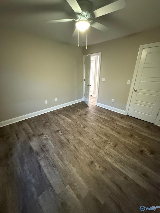 spare room featuring dark hardwood / wood-style floors and ceiling fan