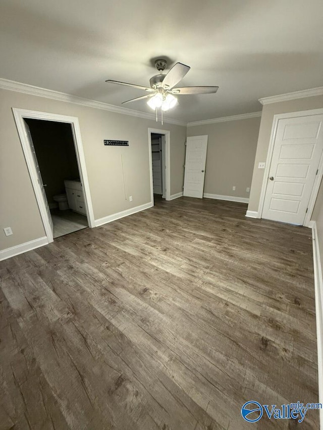 unfurnished bedroom with hardwood / wood-style flooring, ensuite bath, ceiling fan, and crown molding