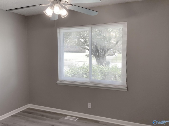 empty room featuring hardwood / wood-style flooring and ceiling fan