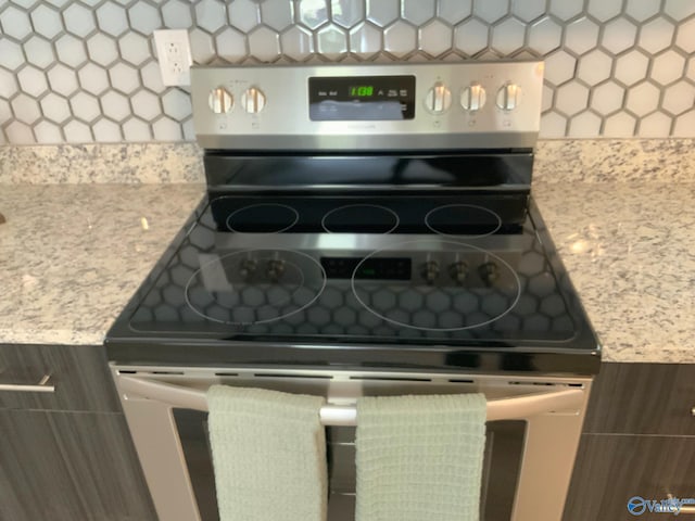 interior details with stainless steel electric stove and dark brown cabinets