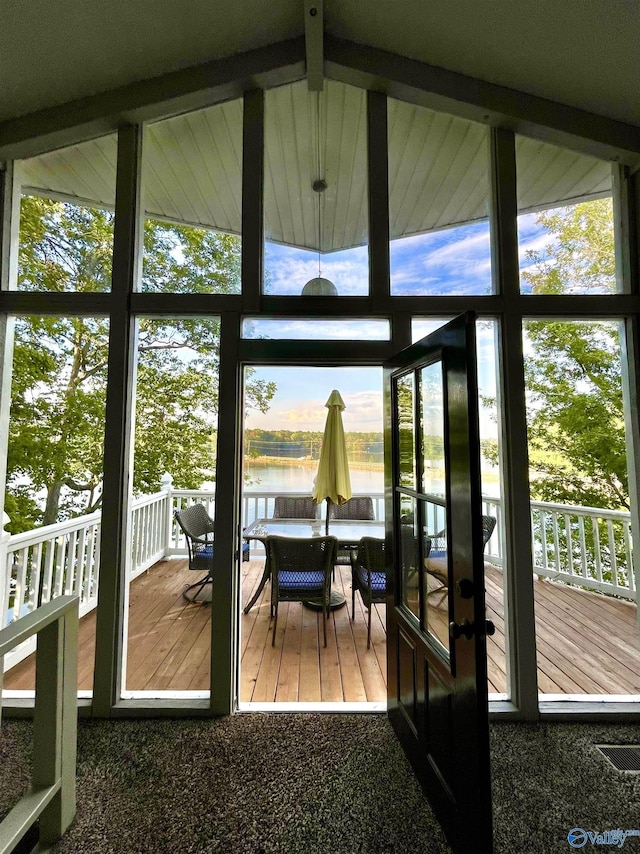 entryway with a water view, floor to ceiling windows, and wood finished floors