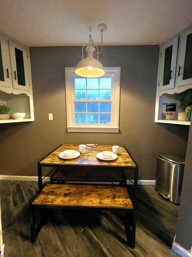dining area featuring baseboards and wood finished floors