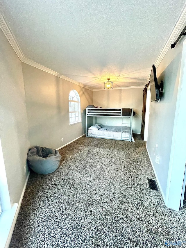 unfurnished bedroom with crown molding, baseboards, carpet flooring, and a textured ceiling