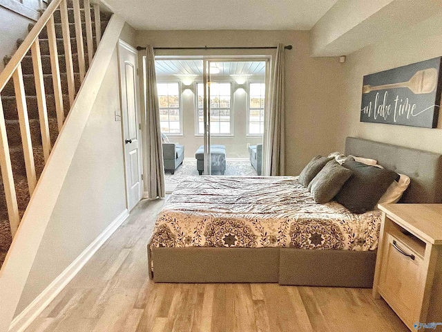 bedroom with light wood-style floors and baseboards