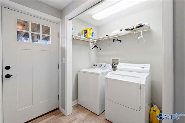 laundry area with light wood-style floors and independent washer and dryer