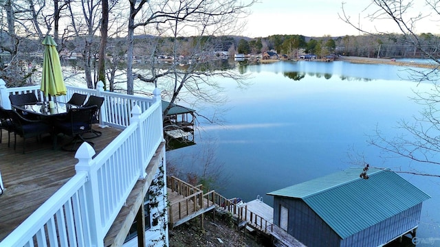 view of dock featuring a water view and outdoor dining area