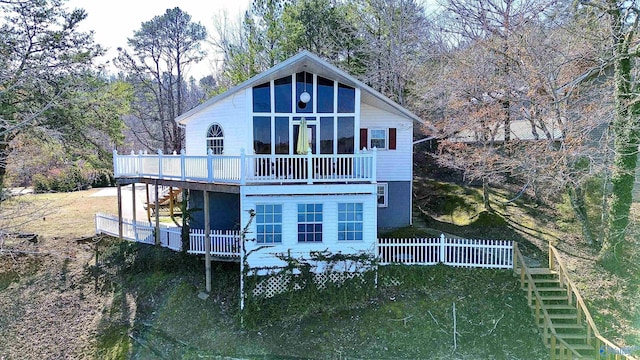 back of property with stairs and a deck
